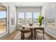 Cozy breakfast nook with a round table, four chairs, and plenty of natural light from the surrounding windows at 1107 Bellwether Ln, Summerville, SC 29485