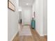 Bright hallway featuring light wood floors, neutral walls, and a stylish accent table at 1107 Bellwether Ln, Summerville, SC 29485