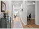 Hallway with wood-look flooring leading to an office space, showcasing the home's seamless flow at 1107 Bellwether Ln, Summerville, SC 29485