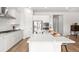 Open kitchen with a large center island, stainless steel appliances, and white cabinets for a clean, modern feel at 1107 Bellwether Ln, Summerville, SC 29485