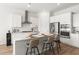 Modern kitchen with white cabinets, stainless steel appliances, and a spacious island with bar seating at 1107 Bellwether Ln, Summerville, SC 29485