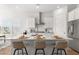 Bright kitchen boasts white cabinetry, stainless steel appliances, and a spacious center island with bar seating at 1107 Bellwether Ln, Summerville, SC 29485