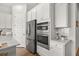 Modern kitchen featuring stainless steel appliances, white cabinets, and a built-in oven and microwave at 1107 Bellwether Ln, Summerville, SC 29485