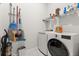 Laundry room with front loading washer and dryer and cleaning supplies neatly stored on rack on wall at 1107 Bellwether Ln, Summerville, SC 29485