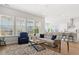 Open-concept living area with ample seating, large windows, and a seamless connection to the adjacent kitchen at 1107 Bellwether Ln, Summerville, SC 29485