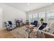 Comfortable living room with plush seating, a decorative rug, and abundant natural light from large windows at 1107 Bellwether Ln, Summerville, SC 29485