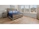 Bedroom features a wooden bed frame, matching nightstands, and ample natural light from the windows at 1107 Bellwether Ln, Summerville, SC 29485