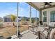 Screened-in porch with ceiling fan, outdoor furniture, and serene backyard view at 1107 Bellwether Ln, Summerville, SC 29485