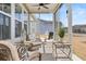 Screened-in porch featuring comfortable seating, a ceiling fan, and backyard views at 1107 Bellwether Ln, Summerville, SC 29485