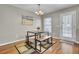 The dining room features a modern table with bench seating on a decorative rug, and a view of the exit door at 112 Avonshire Dr, Summerville, SC 29483