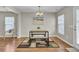 The dining room features a modern table with bench seating on a decorative rug, bathed in natural light at 112 Avonshire Dr, Summerville, SC 29483