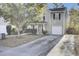 Two-story home featuring neutral siding, black shutters, a one-car garage, and mature trees in a well-maintained yard at 112 Avonshire Dr, Summerville, SC 29483