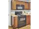 Kitchen features wood cabinets, black appliances, and light countertops at 112 Avonshire Dr, Summerville, SC 29483