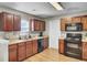 Spacious kitchen features wood cabinets, stainless steel sink, and black appliances at 112 Avonshire Dr, Summerville, SC 29483