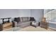 Comfortable living area with gray couch and decorative side tables and lamps at 112 Avonshire Dr, Summerville, SC 29483