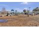 Community playground with slides, swings, and climbing structures, near a pond at 112 Avonshire Dr, Summerville, SC 29483