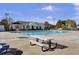 Community pool with a covered seating area and picnic tables on a sunny day at 112 Avonshire Dr, Summerville, SC 29483