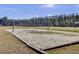 Outdoor sand volleyball court with a net, surrounded by grass and trees at 112 Avonshire Dr, Summerville, SC 29483