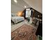 Charming bedroom with a unique brick accent wall, wooden desk, plush rug and warm natural light at 122 Mellard Dr, Goose Creek, SC 29445