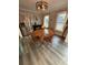 Cozy dining area with wood table, a stainless steel refrigerator and two large windows with lots of natural light at 122 Mellard Dr, Goose Creek, SC 29445