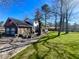 Charming brick home featuring a spacious yard, patio, and a two-car garage with an American flag at 122 Mellard Dr, Goose Creek, SC 29445
