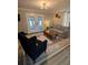 Comfortable living room featuring a cozy seating area, a wooden coffee table, and access to the sunroom at 122 Mellard Dr, Goose Creek, SC 29445