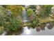 Aerial perspective highlighting a tranquil lakefront property, enveloped by lush trees and complete with screened in porch at 132 Lipman St, Summerville, SC 29483