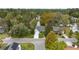 Aerial view of a charming home nestled among trees, boasting a manicured yard and proximity to a serene pond at 132 Lipman St, Summerville, SC 29483