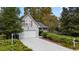 Single-Gathering home featuring a well-maintained lawn, mature trees, and an attached two-car garage at 132 Lipman St, Summerville, SC 29483