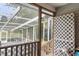 A screened porch with a white lattice and door frame allows natural light to filter in at 132 Lipman St, Summerville, SC 29483