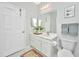 Bright bathroom with white vanity, ample lighting, decorative mirrors, and elegant marble floors at 1581 Cambridge Lakes Dr, Mount Pleasant, SC 29464