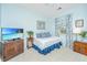 Cozy bedroom with beautiful blue accents, side tables and television with island picture at 1581 Cambridge Lakes Dr, Mount Pleasant, SC 29464