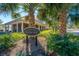 Club House and sign surrounded by well maintained landscaping and mature palm trees on a sunny day at 1581 Cambridge Lakes Dr, Mount Pleasant, SC 29464