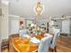 Elegant dining room featuring a stylish chandelier, hardwood floors, and a view of the living area at 1581 Cambridge Lakes Dr, Mount Pleasant, SC 29464