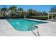 Community pool with clear blue water and access ladders surrounded by lush greenery at 1581 Cambridge Lakes Dr, Mount Pleasant, SC 29464
