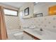 Cozy bathroom with tub-shower, patterned tile, and a white vanity at 1615 E Ashley Ave, Folly Beach, SC 29439