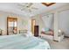 A cozy bedroom with two beds, a ceiling fan, and a view to another room with a bed at 1615 E Ashley Ave, Folly Beach, SC 29439