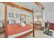 Bedroom with wooden canopy bed, neutral walls, and desk near stairway at 1615 E Ashley Ave, Folly Beach, SC 29439