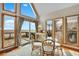 Cozy dining area with a glass table, wicker chairs, and a view of the ocean from the windows at 1615 E Ashley Ave, Folly Beach, SC 29439
