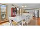 A dining room with a white dining table and chairs adjacent to the kitchen at 1615 E Ashley Ave, Folly Beach, SC 29439