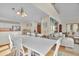 A large white table with seating for ten sits between the kitchen and the living room at 1615 E Ashley Ave, Folly Beach, SC 29439