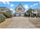 Beautiful two-story home features a two-car garage, private balcony, and a spacious driveway at 1615 E Ashley Ave, Folly Beach, SC 29439