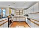 Kitchen with white cabinets, stainless steel appliances and hardwood floors at 1615 E Ashley Ave, Folly Beach, SC 29439
