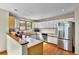 A kitchen with wooden floors, white cabinets, and stainless steel appliances at 1615 E Ashley Ave, Folly Beach, SC 29439