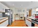 Kitchen with white cabinets, stainless steel refrigerator, and wooden shelving at 1615 E Ashley Ave, Folly Beach, SC 29439