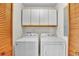 Convenient laundry area featuring a washer, dryer, and ample storage cabinets at 1615 E Ashley Ave, Folly Beach, SC 29439