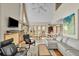 Spacious living room featuring a soaring ceiling, large windows, and comfortable seating arrangement at 1615 E Ashley Ave, Folly Beach, SC 29439