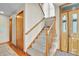Welcoming entryway featuring staircase with wood railing and a wooden front door at 1615 E Ashley Ave, Folly Beach, SC 29439