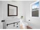 Modern half bathroom with shiplap vanity, a stylish mirror, and a window for natural light at 1738 N N Hwy 52, Bonneau, SC 29431