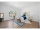 Bright bedroom features hardwood floors, a decorative headboard, and two windows offering natural light at 1738 N N Hwy 52, Bonneau, SC 29431